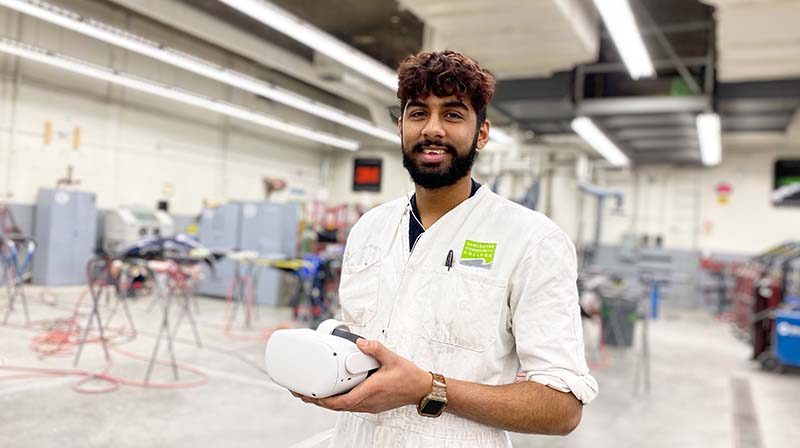 VCC student holds virtual reality headset