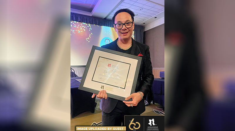 Dr. Paul Yeung holds award for Canadian Counselling and Psychotherapy Association