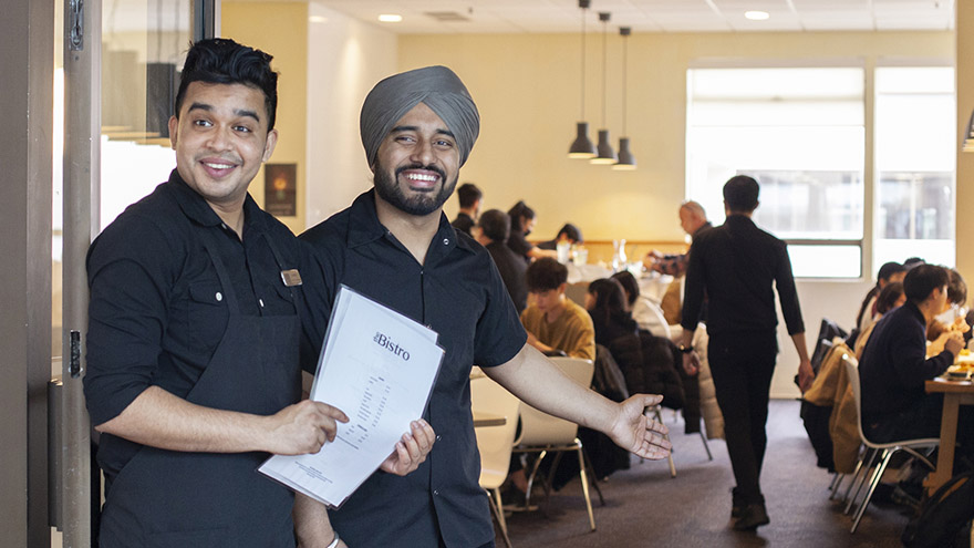 VCC Hospitality students greeting at the entrance to the Bistro