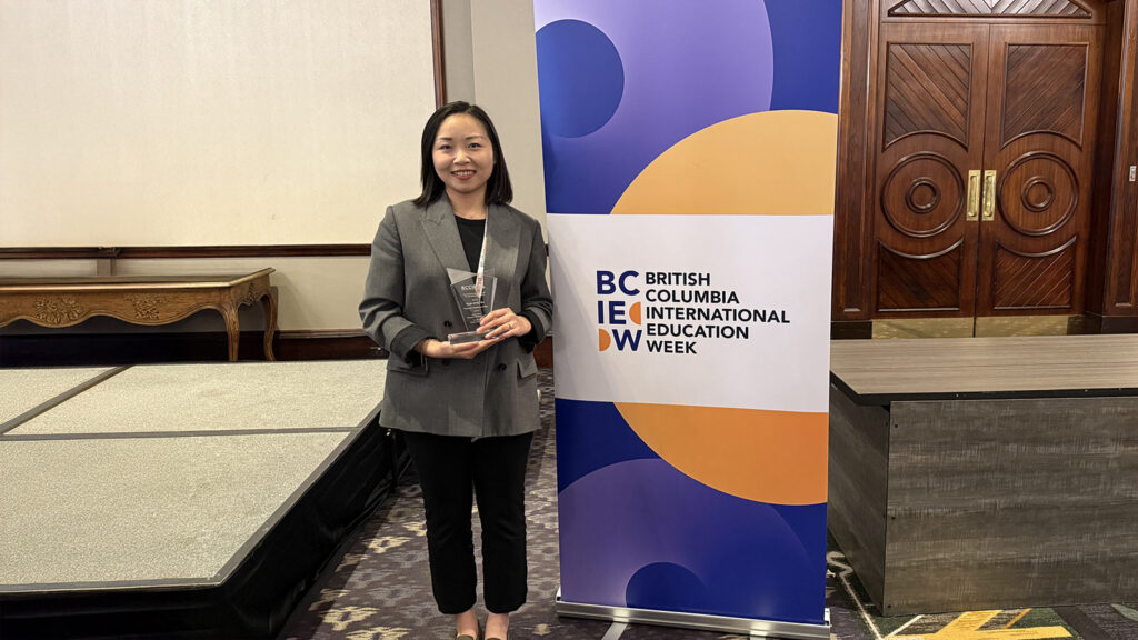 Emily Chen holding an award for  International Education Award