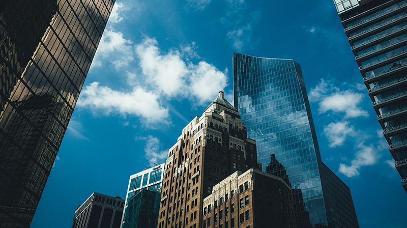 Vancouver office buildings against blue sky with clouds